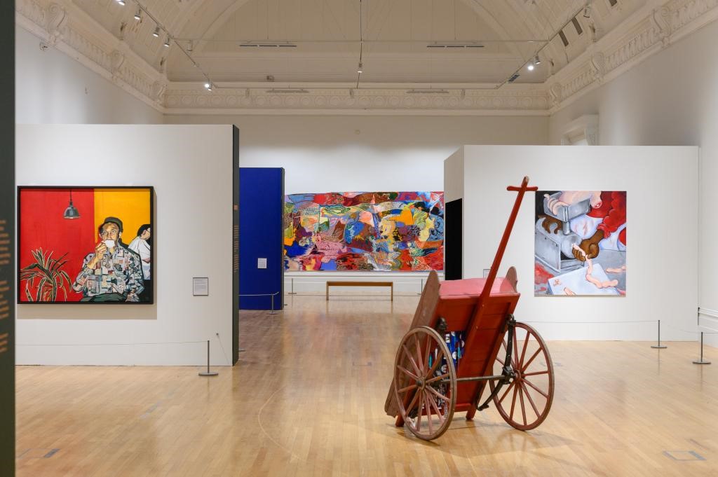 A room with art and paintingsDescription automatically generated