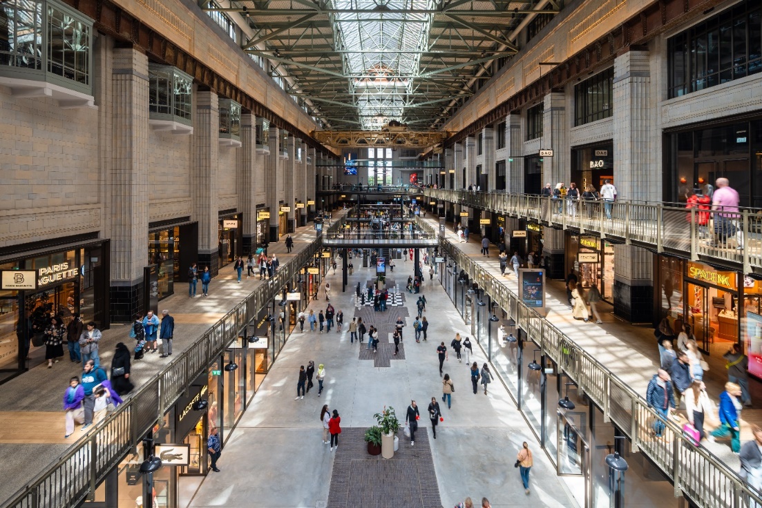 A large building with many people walkingDescription automatically generated