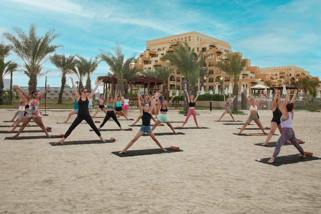 A group of people doing yogaAI-generated content may be incorrect.