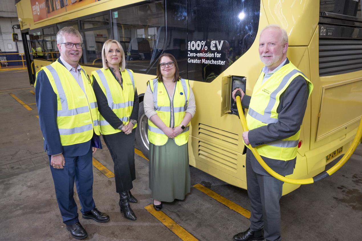  Transport Commissioner Vernon Everitt testing out the new charging infrastructure equipment with Stephen Rhodes - Director of Bus, Anne Marie Purcell - Chief Transformation Officer, and Zoe Hands, Managing Director of First Bus, Manchester. 