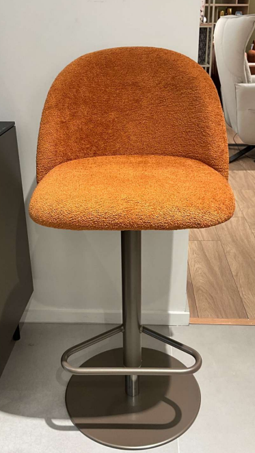 An orange chair with a metal baseAI-generated content may be incorrect.