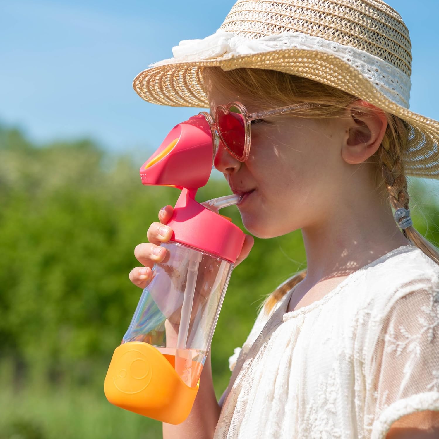 A child wearing a hat and sunglasses drinking from a strawAI-generated content may be incorrect.