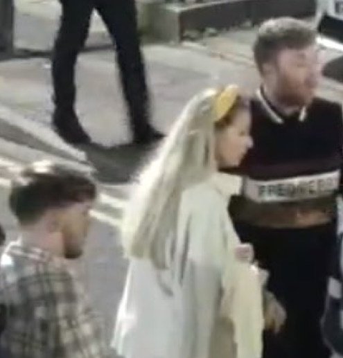 Two men, one in a check shirt and the other in a black and white t-shirt, and a female in a stone coloured top with a yellow headband