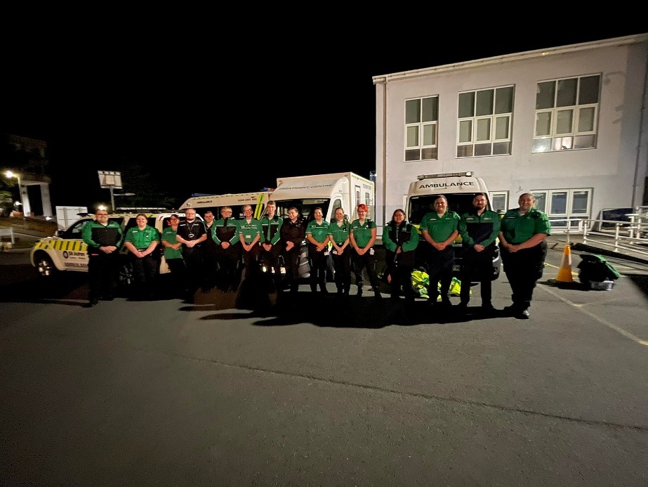 A group of people in green shirtsDescription automatically generated