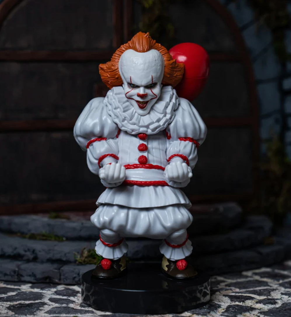 A clown figurine on a stone surfaceDescription automatically generated