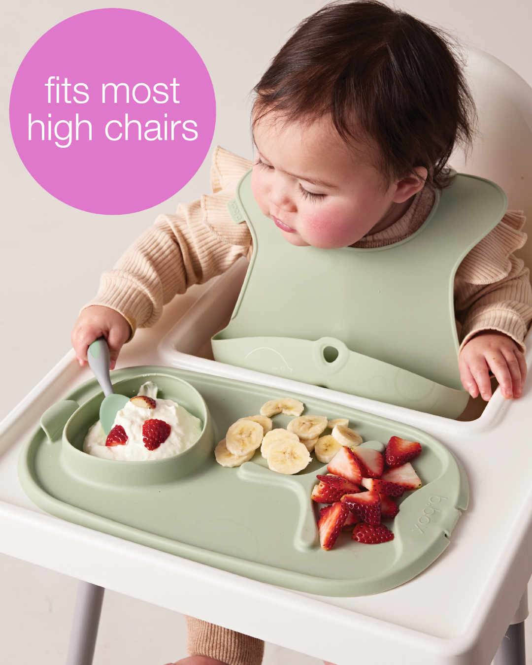 A baby eating food from a high chairAI-generated content may be incorrect.
