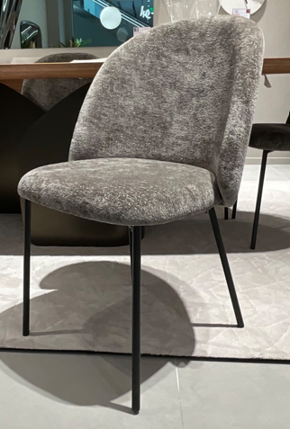 A grey chair with black legsAI-generated content may be incorrect.