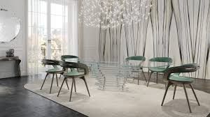 A room with a chandelier and chairsDescription automatically generated