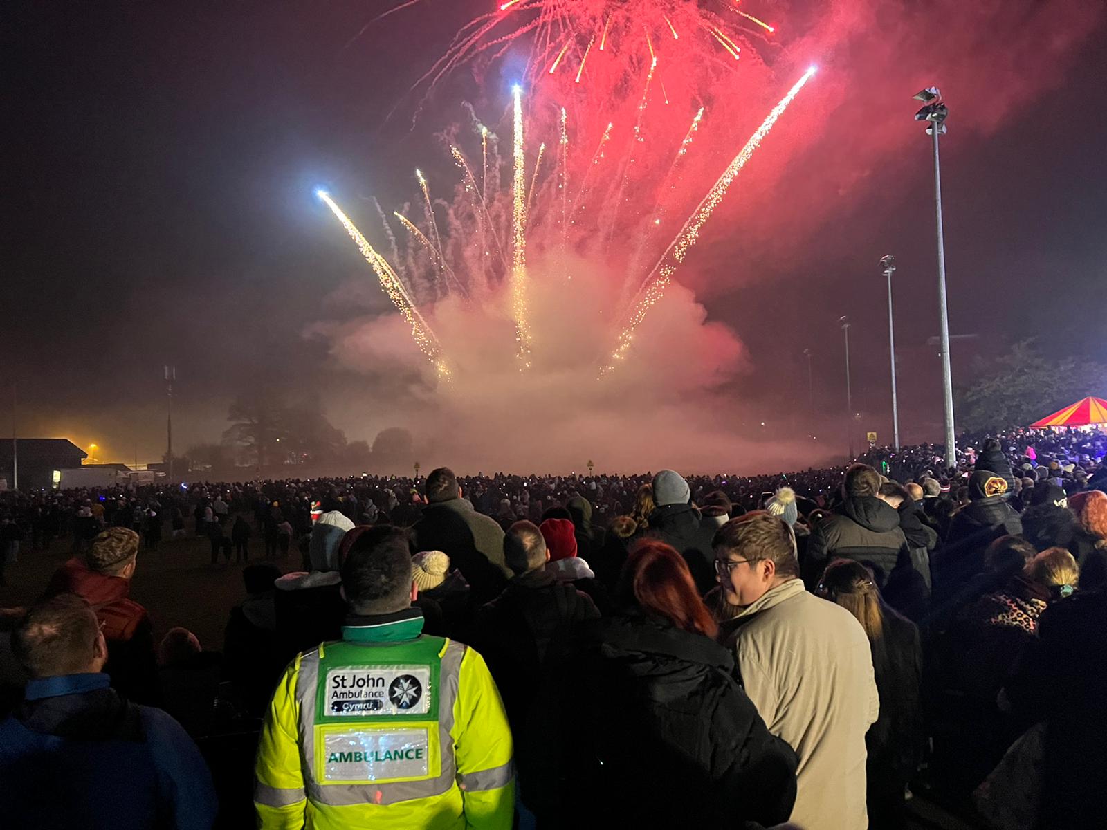 A crowd of people watching fireworksDescription automatically generated
