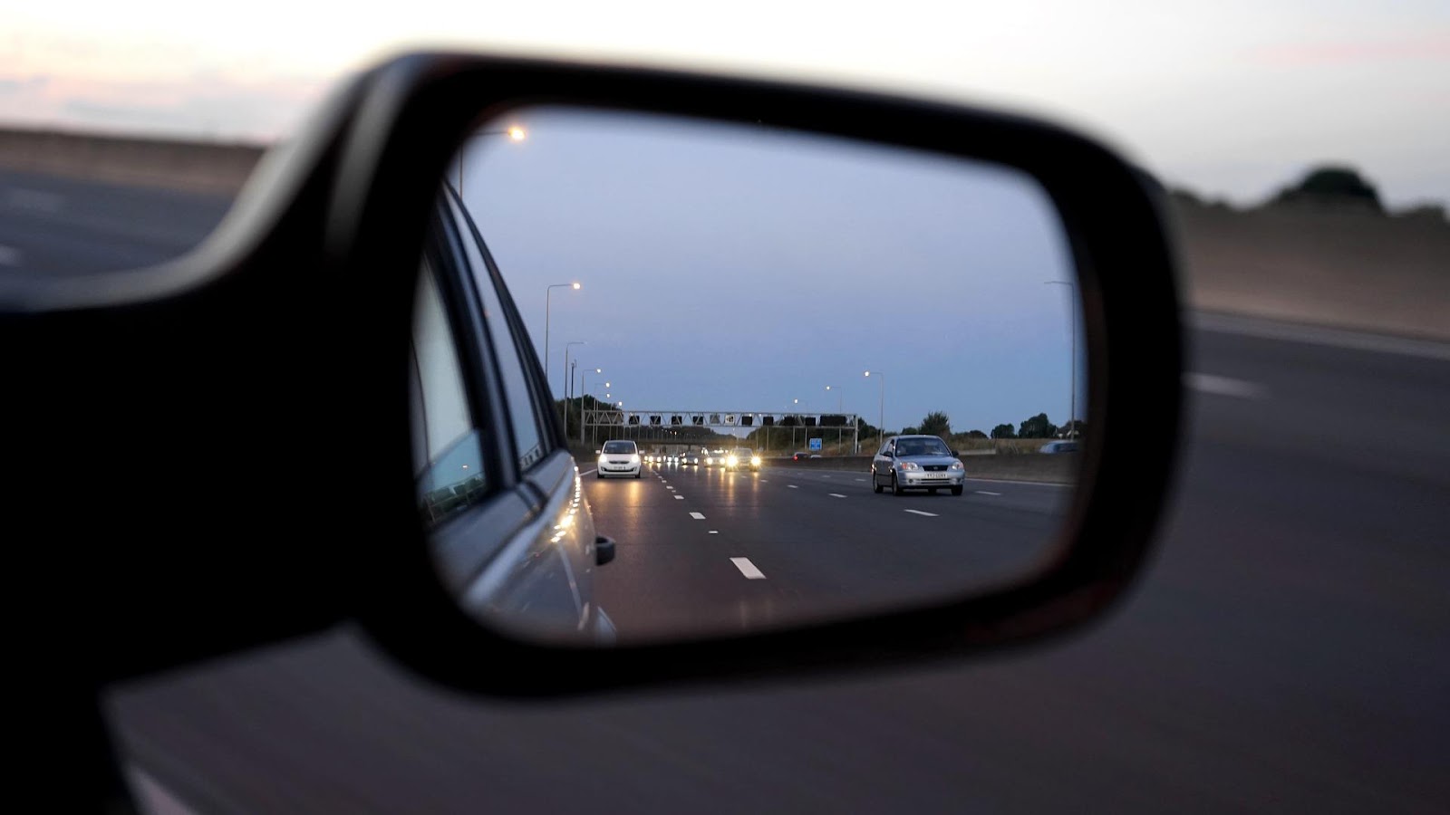 A picture containing mirror, car mirror, object, carDescription automatically generated