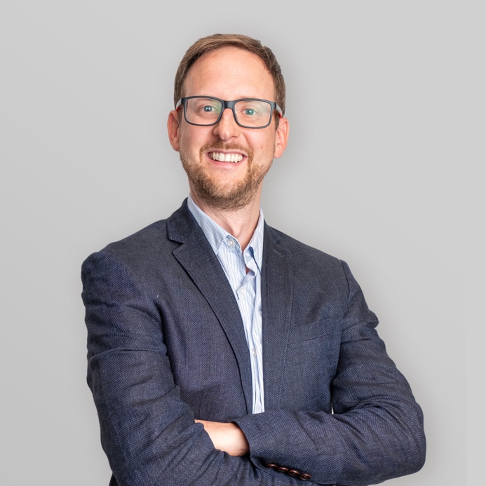 A picture containing person, person, suit, wallDescription automatically generated