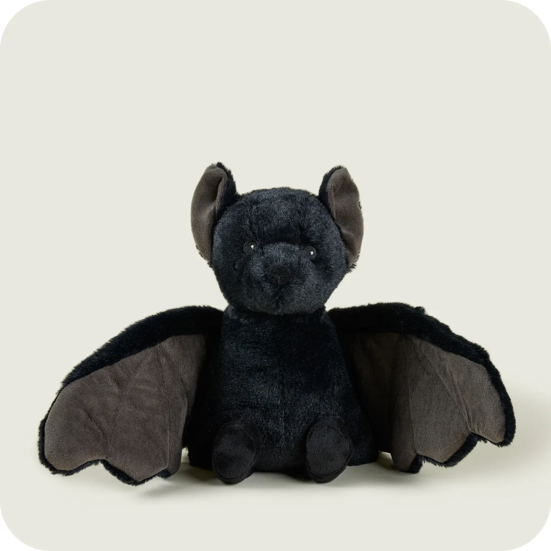 A stuffed animal bat with wingsDescription automatically generated