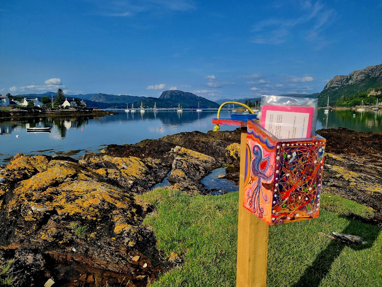 A mailbox on a rocky shoreAI-generated content may be incorrect.