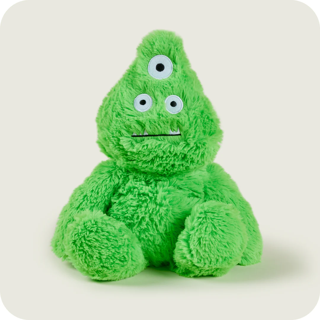 A green stuffed animal with three eyesDescription automatically generated