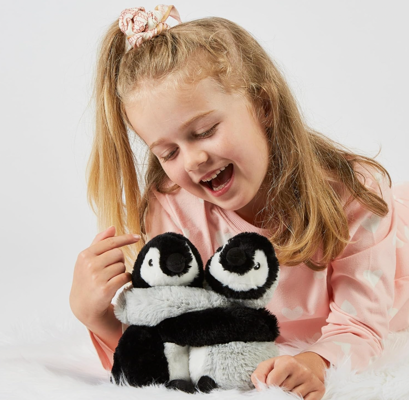 A child with a stuffed animalDescription automatically generated