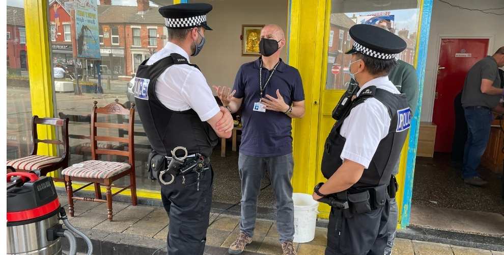 GLAA officer and two police officers outside hand car wash