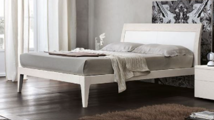 A bed with a white headboardAI-generated content may be incorrect.