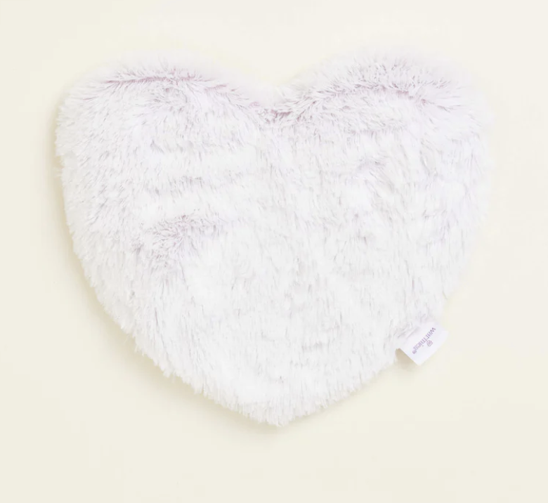 A white fluffy heart shaped pillowDescription automatically generated