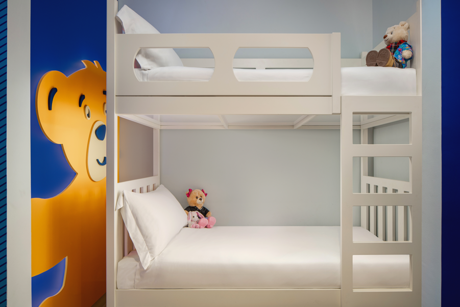 A bunk bed with a stuffed animalDescription automatically generated