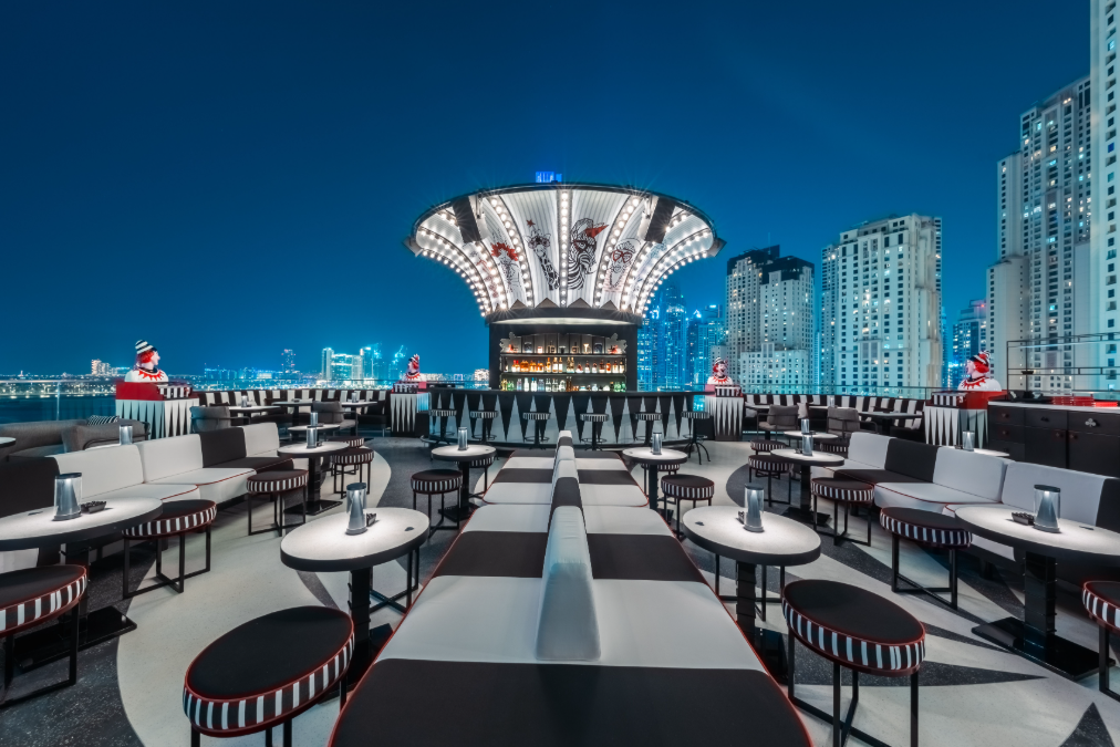 A rooftop restaurant with tables and chairsDescription automatically generated