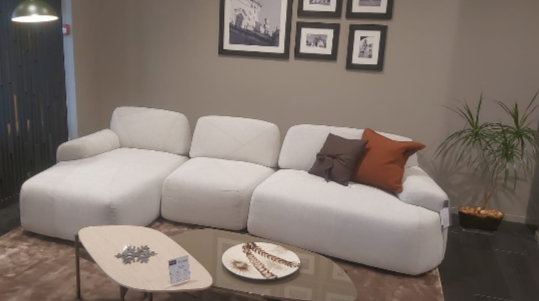 A white couch in a roomDescription automatically generated