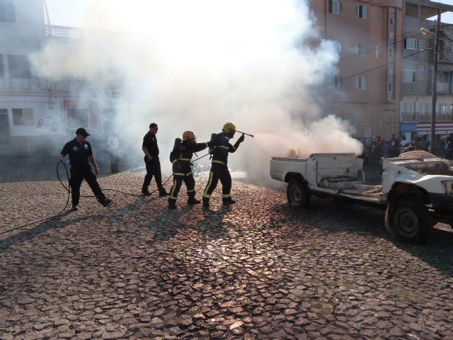 Cape Verde firefighters tackling fire coming from a vehicle