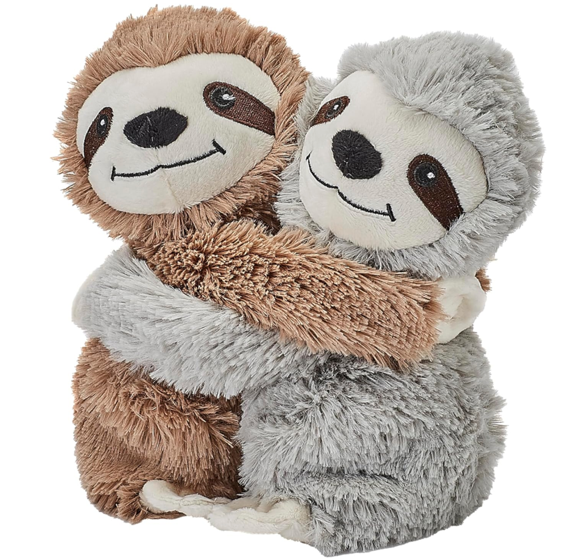 Two stuffed animals hugging each otherDescription automatically generated